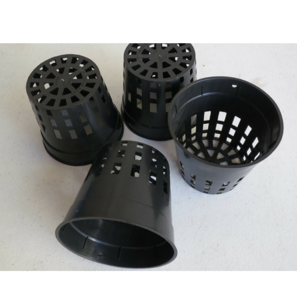 four small black plastic pots with holes on the sides